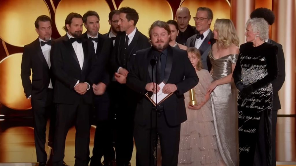 The Brutalist cast at the 82nd Golden Globes after winning Best Picture – Drama award