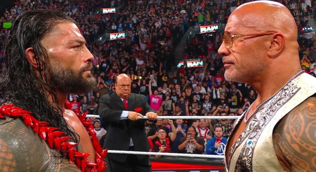 Roman Reigns and Dwayne Johnson staring at each other fiercely on Netflix's WWE Raw