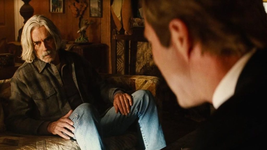 Sam Elliott looking sad during a discussion with Aaron Eckhart in Thank You for Smoking