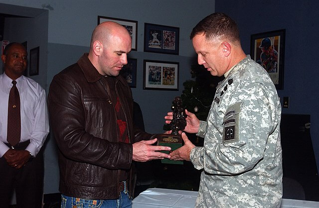 Dana White receives an iron -Mike statue from Brig. General William Mayville