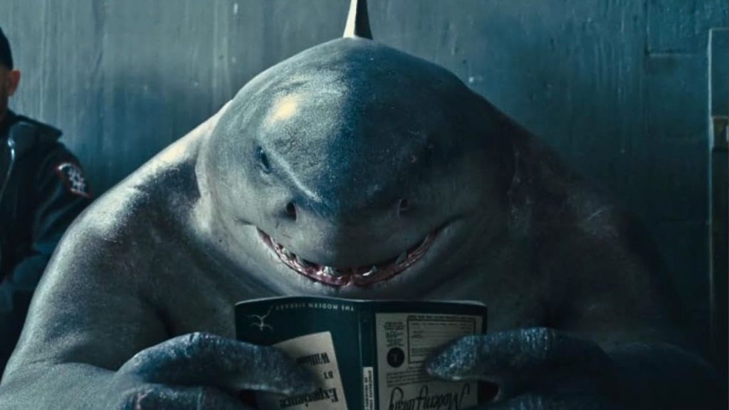 King Shark reading book in The Suicide Squad 