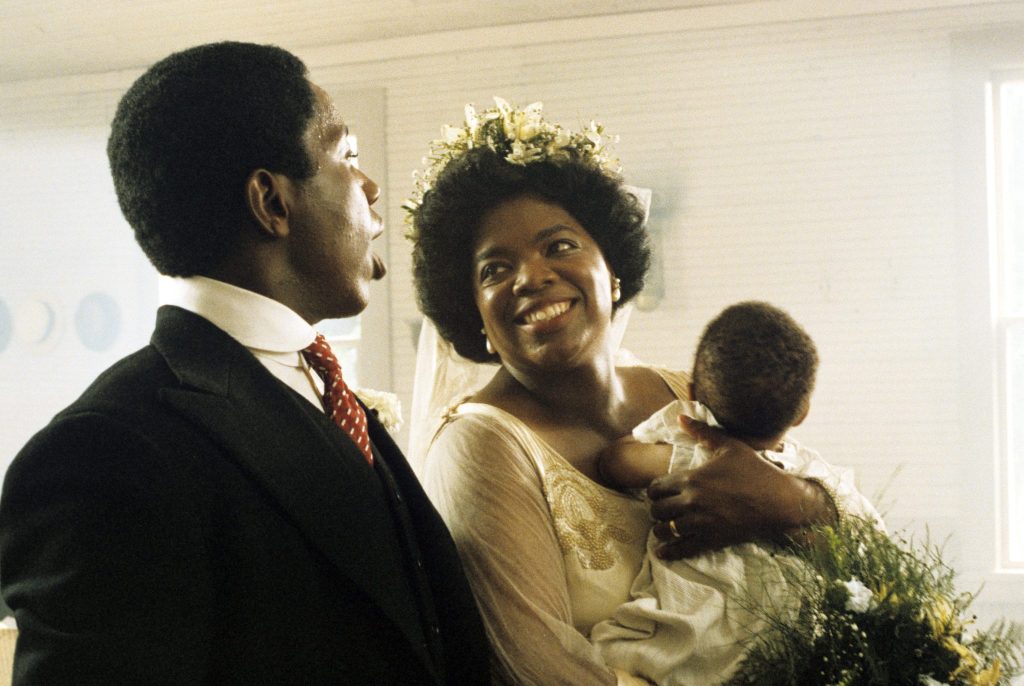 Willard E. Pugh looking at Oprah Winfrey, who is carrying a child in The Color Purple
