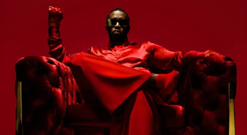 Diddy wears red and sits on a throne