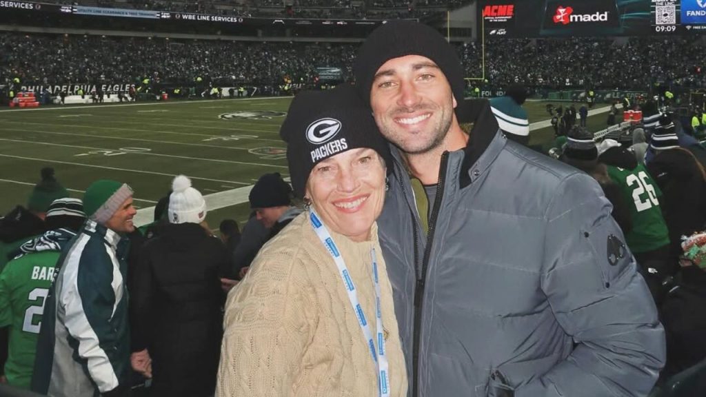 Joey Graziadei with his mother during a Green Bay Packers football match