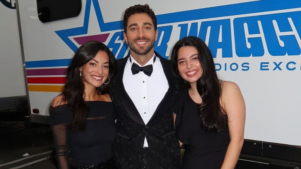 Joey Graziadei posing with his two sisters, Carly and Ellie, for a picture