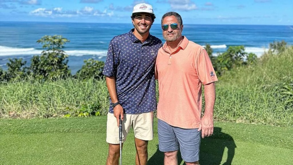 Joey Graziadei with his father posing for a picture while playing golf