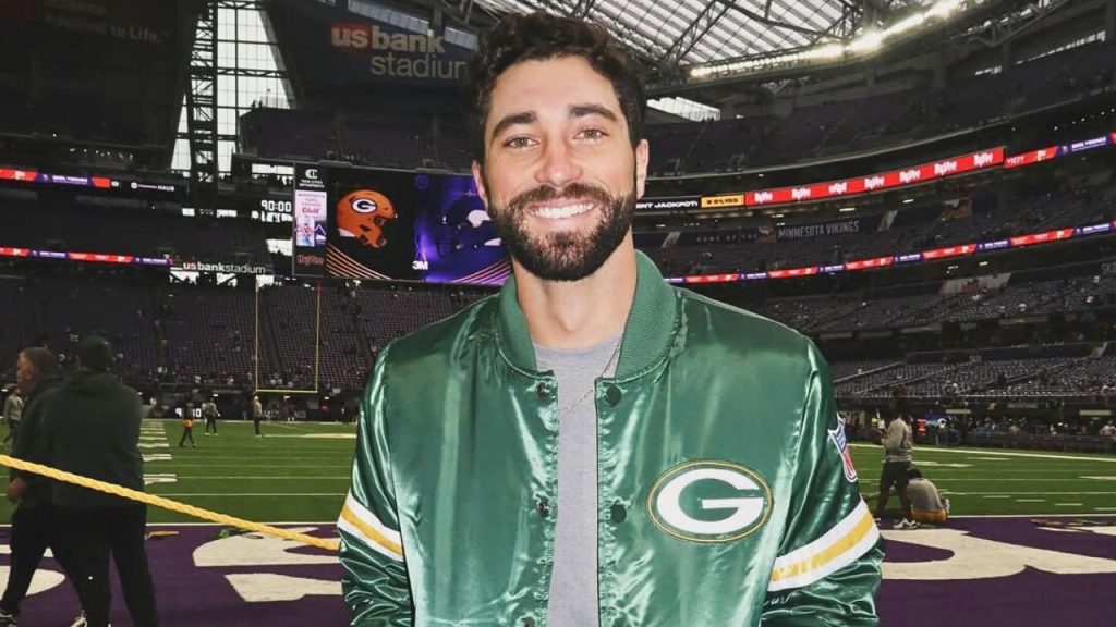 Joey Graziadei posing for a picture during a football game