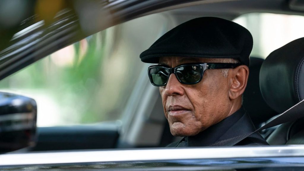 Giancarlo Esposito sitting in a car while wearing black sunglasses in Parish