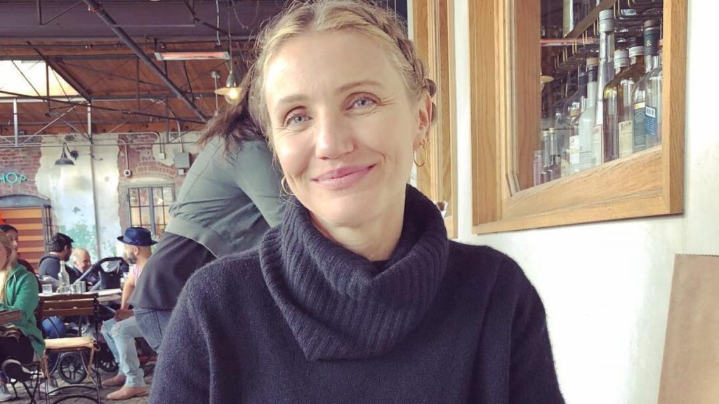 Cameron Diaz smiling for a picture inside a restaurant