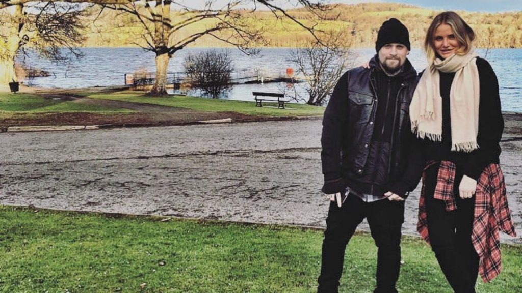 Cameron Diaz and Benji Madden posing for a picture outside in front of a lake