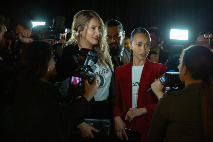 Emilia Perez and Rita Mora from the movie surrounded by photographers