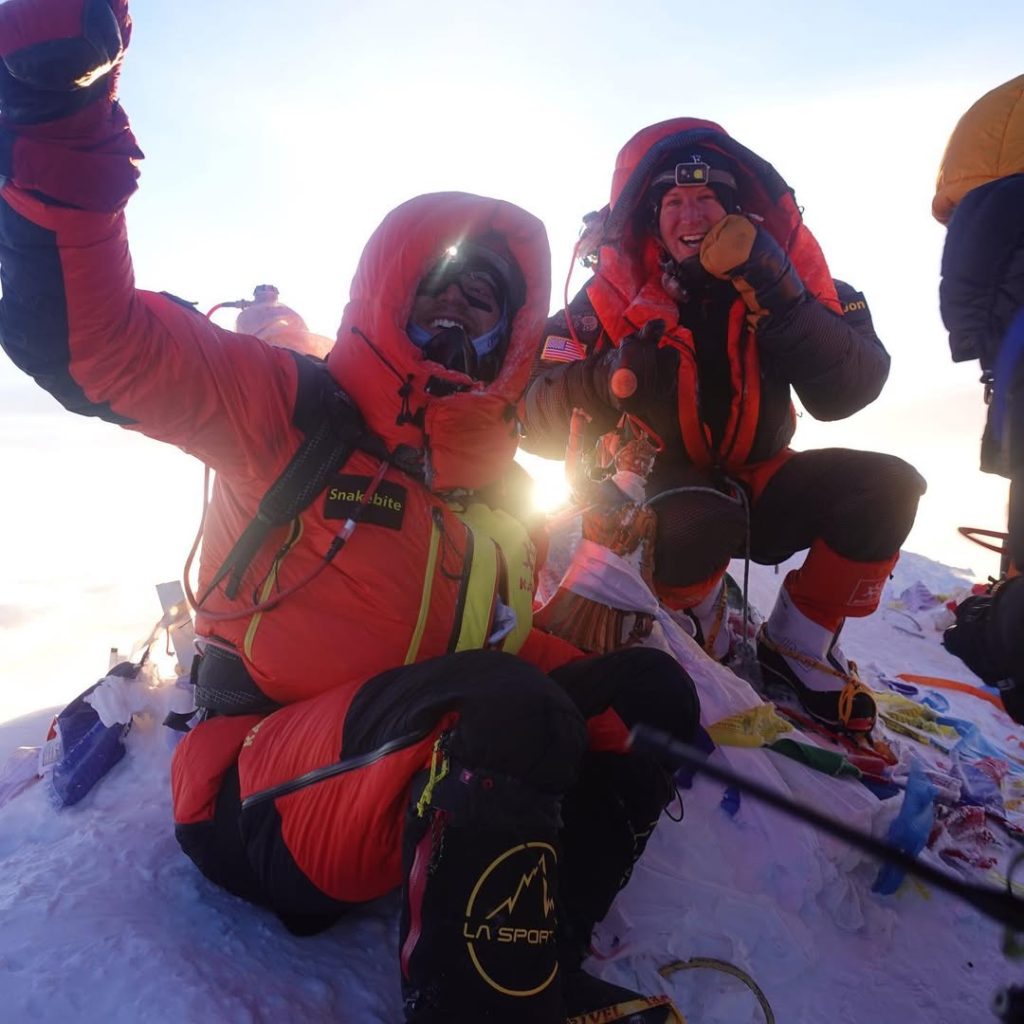 Mike Posner and his friend click a picture at the top of Mount Everest.