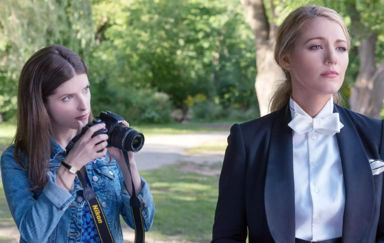 Anna Kendrick as Stephanie Smothers clicky photos of Blake Lively as Emily Nelson in the movie A Simple Favor.