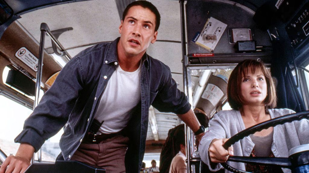Sandra Bullock and Keanu Reeves in speed where she is driving the bus