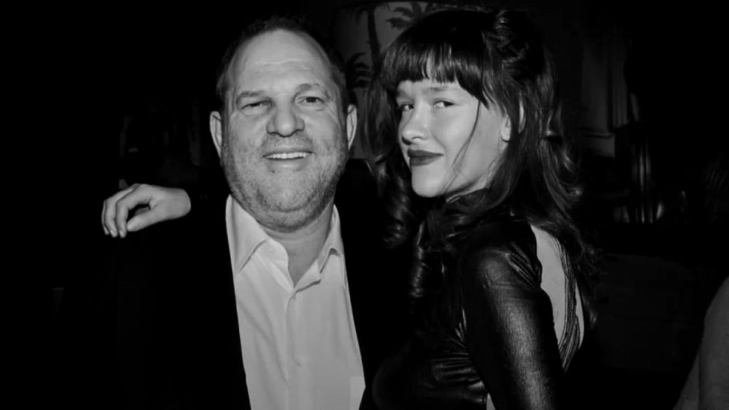 Paz de la Huerta keeping her arm over the shoulders of Harvey Weinstein 