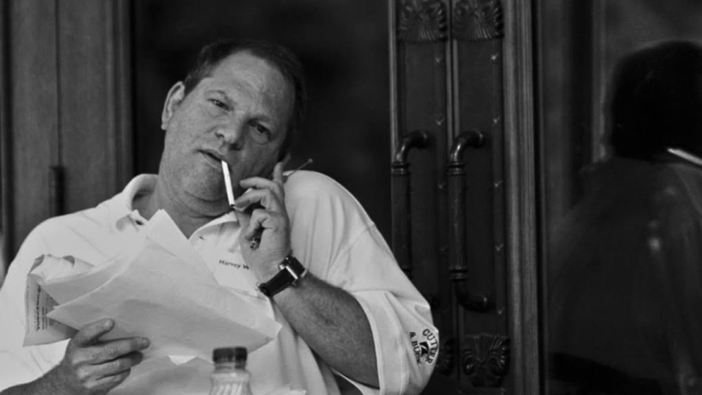 Harvey Weinstein on a phone call while smoking cigarette