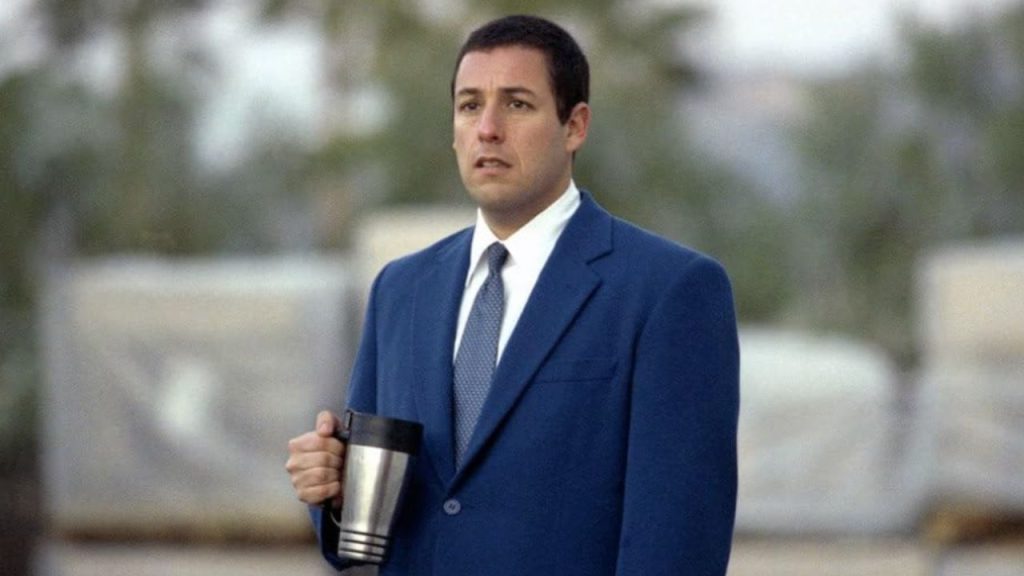 A still from Punch-Drunk Love featuring Adam Sandler with a thermos in hand.