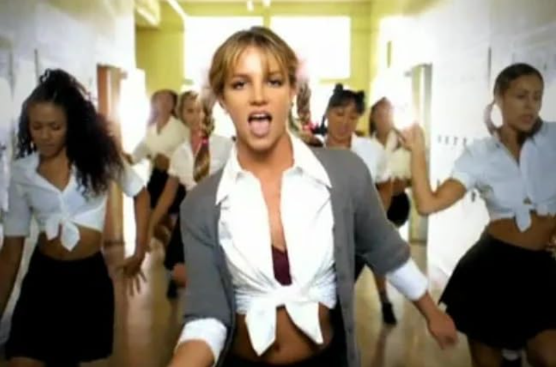 Britney Spears singing and dancing in the music video Baby One More Time.