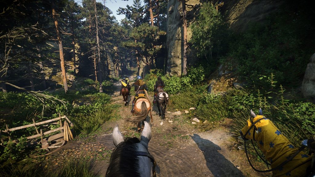 A screenshot of a group of medieval soldiers riding horses through the woods in Kingdom Come: Deliverance 2. 