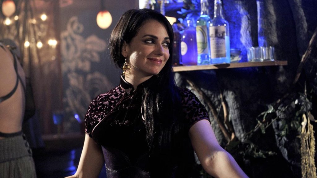 Mia Kirshner smiling while looking sideways in Defiance