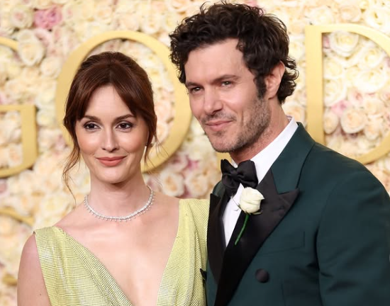 Leighton Meester in a citrus-hued dress with her husband Adam Brody wearing a teal suit at the Golden Globe 2025.