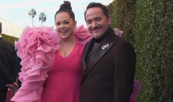 Melissa McCarthy wearing pink with her husband Ben Falcone wearing a brown suit at the Golden Globe 2025.