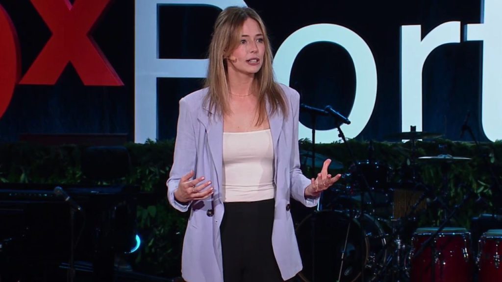 Emily Nestor giving a speech on stage