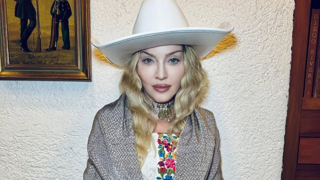 Madonna wearing a hat, posing for a picture