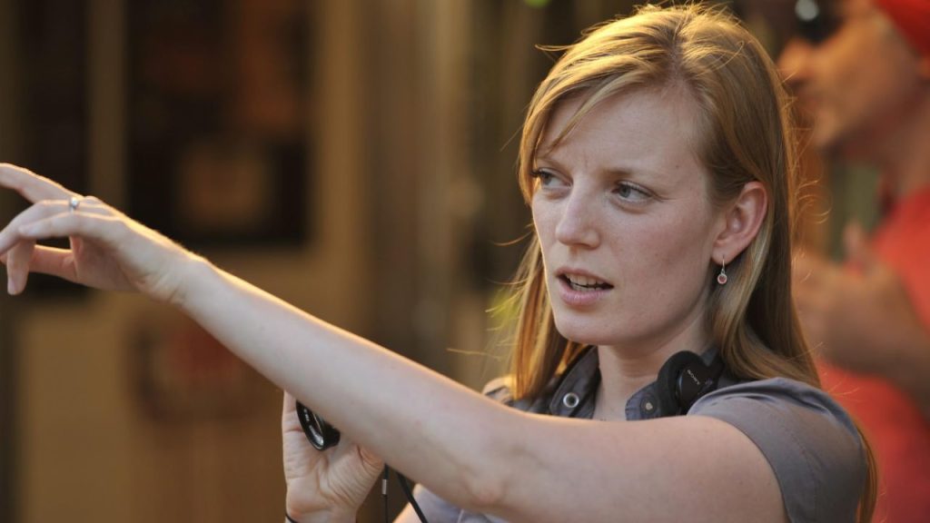 Sarah Polley pointing at something whike holding a camera in Take This Waltz 