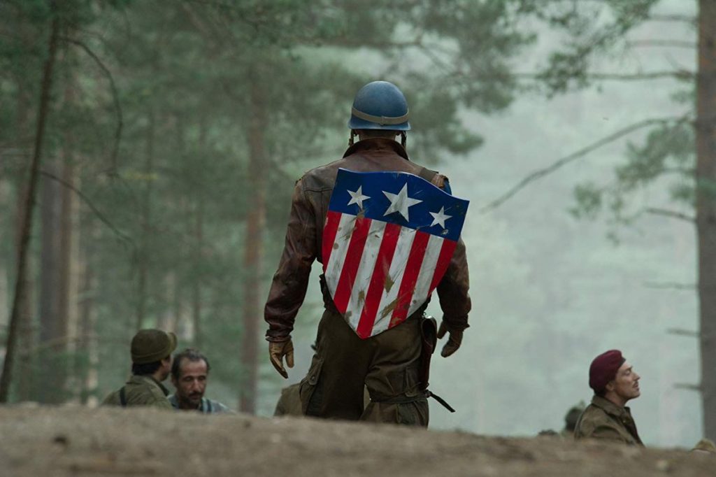 "That's not true, though": One Avengers Star Has Already Debunked Chris Evans in Doomsday Rumor 2 Chris Evans has his turned back to us and is wearing the old shield of Captain America with a soldier's outfit in a battlefield in a still from Captain America: The First Avenger.