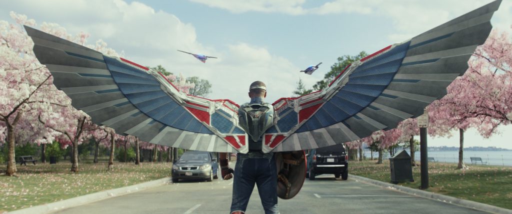 Captain America/Sam Wilson (Anthony Mackie) blocking the presidential convoy with his mechanical wings in Marvel Studios' Captain America: Brave New World.