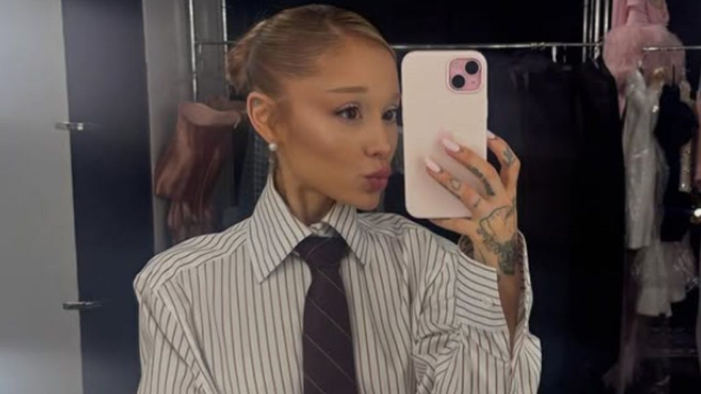 Ariana Grande wearing tie and a striped shirt