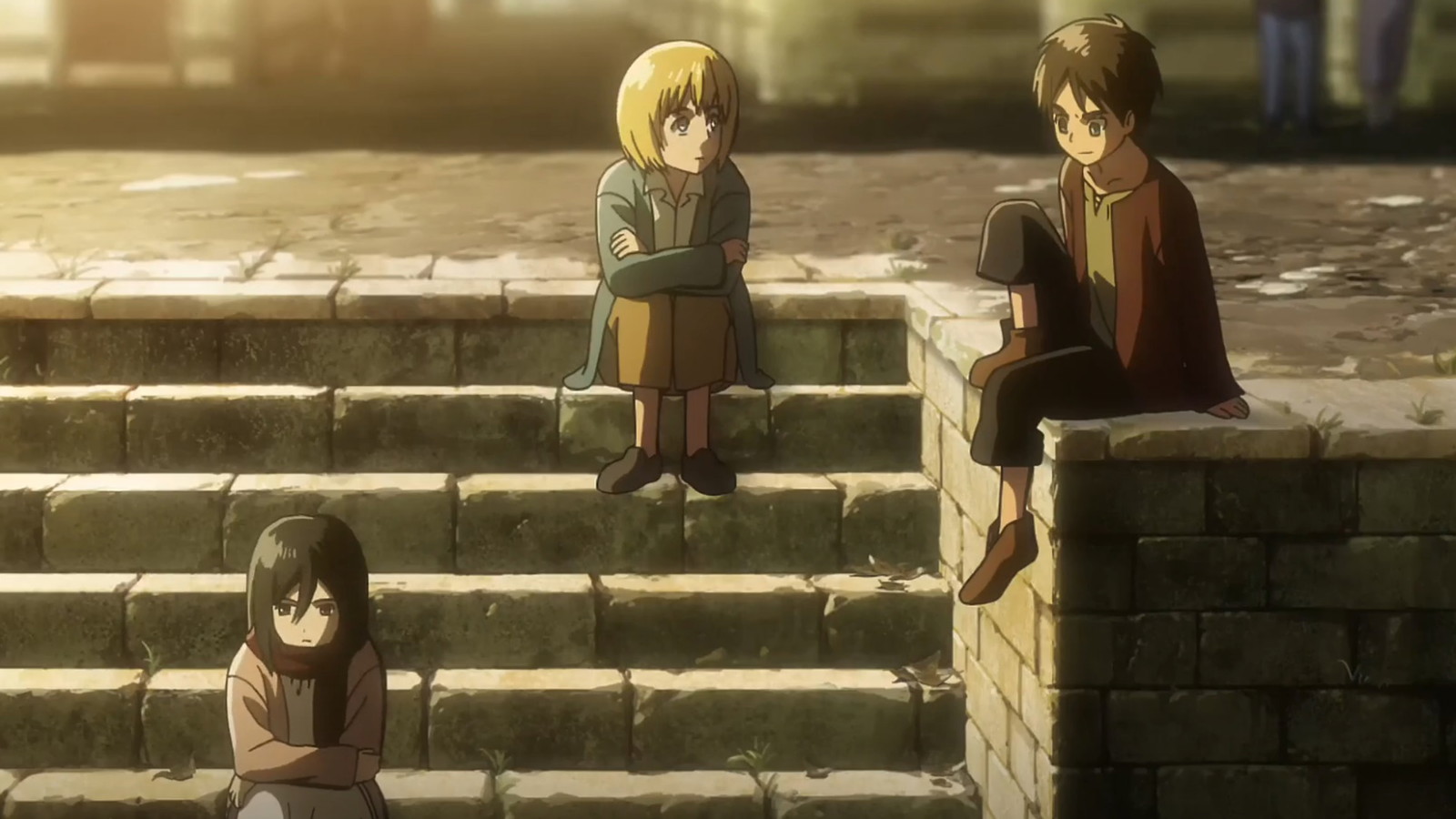 Armin, Mikasa, and Eren are sitting on the stairs in a still from Attack on Titan anime