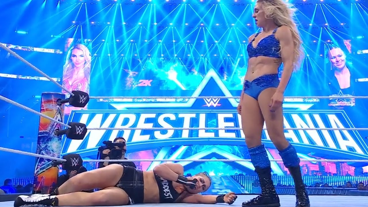 Charlotte Flair standing tall over Ronda Rousey