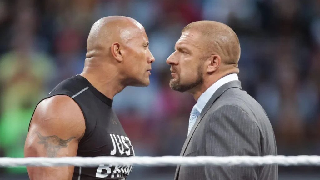 The Rock and Triple H face off on the ring