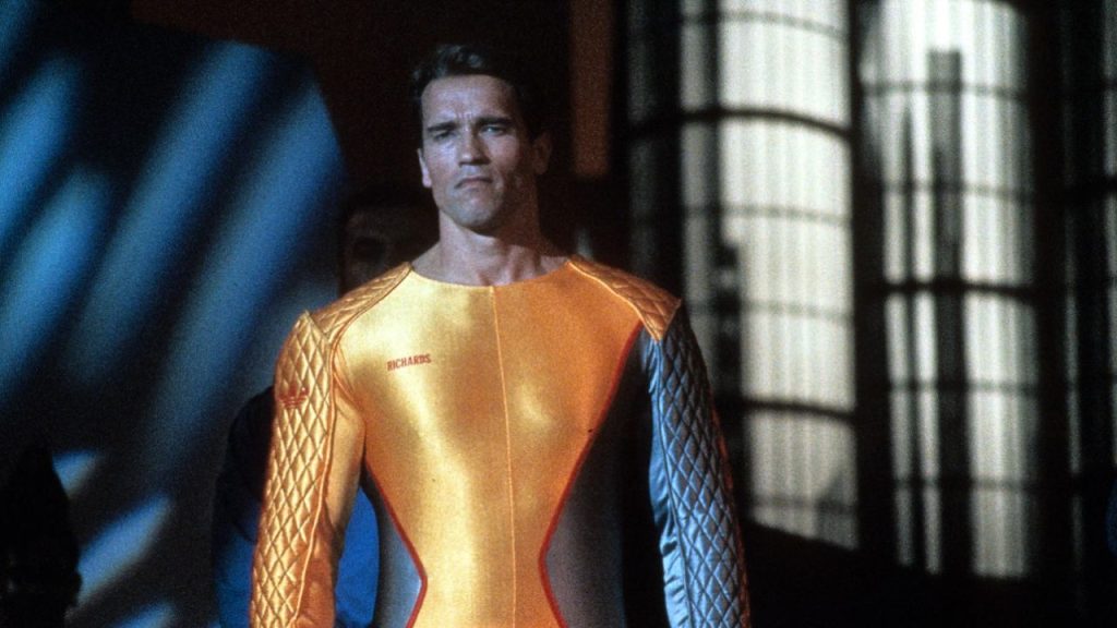 Arnold Schwarzenegger looking seriously at something in The Running Man