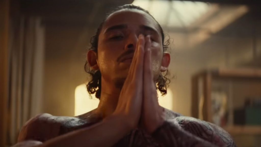 Anthony Ramos closing his eyes and folding his hands in Ironheart 