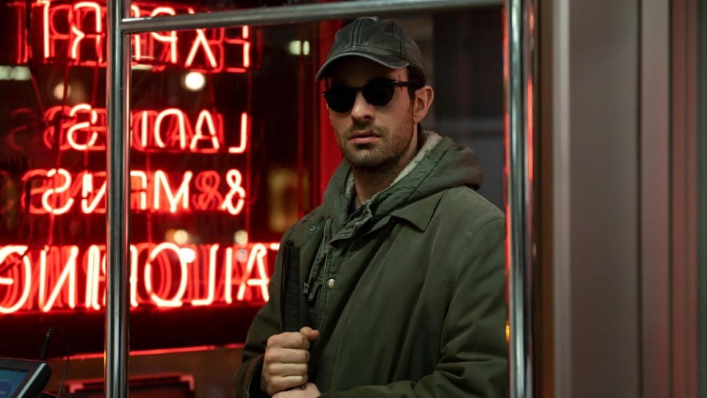 Charlie Cox holding a blind stick in Daredevil