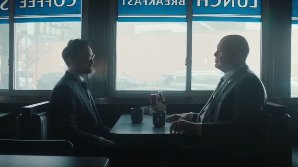 Charlie Cox and Vincent D'Onofrio talking to each other in a restaurant in Daredevil: Born Again 