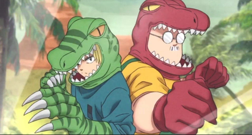 Shin and Taro Sakamoto wearing dinosaur themed headgear and gloves.