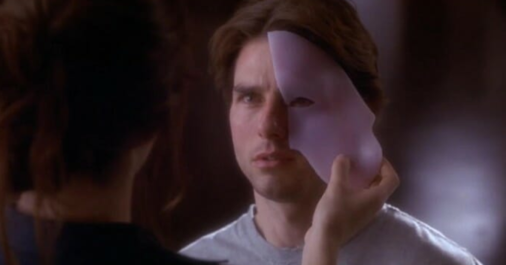 Tom Cruise as David Ames trying on a mask. 