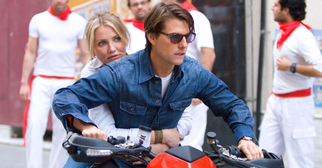 Cameron Diaz as June and Tom Cruise as Roy Miller running from the bad guys in a motorbike. 