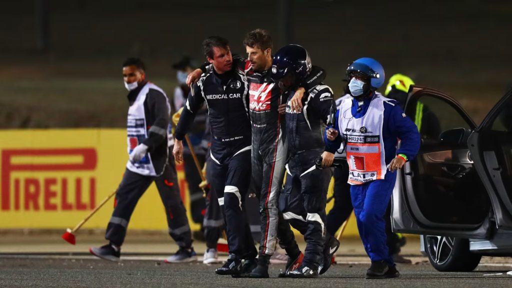 Romain Grosjean (center) walks away from fiery crash in Bahrain.