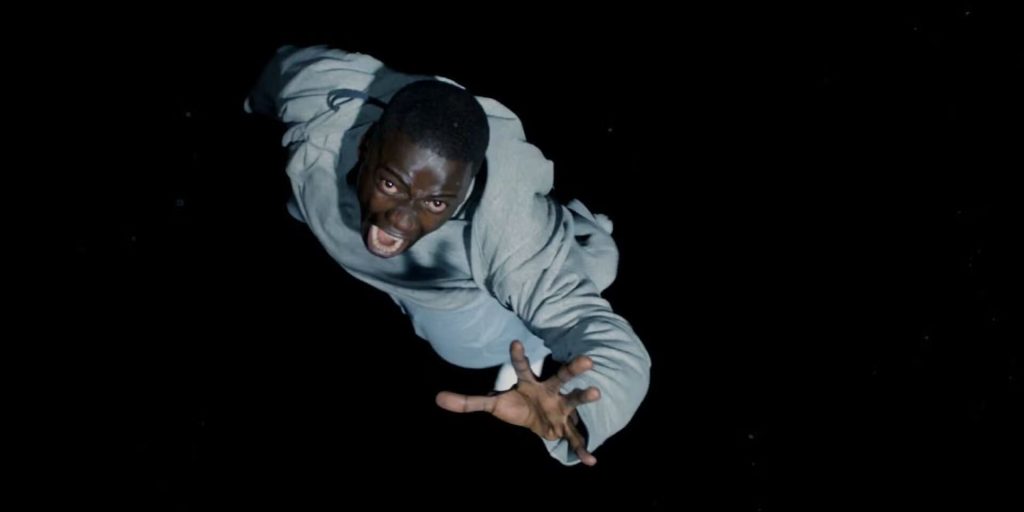 Daniel Kaluuya in a scene from "Get Out," falling into the Sunken Place with a terrified expression on his face, arms outstretched.