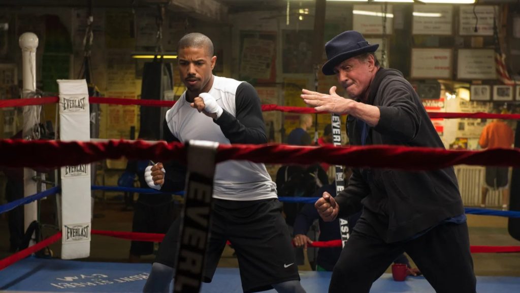 Adonis Creed (Michael B. Jordan) training in a boxing ring with Rocky Balboa (Sylvester Stallone) coaching him in a scene from "Creed."