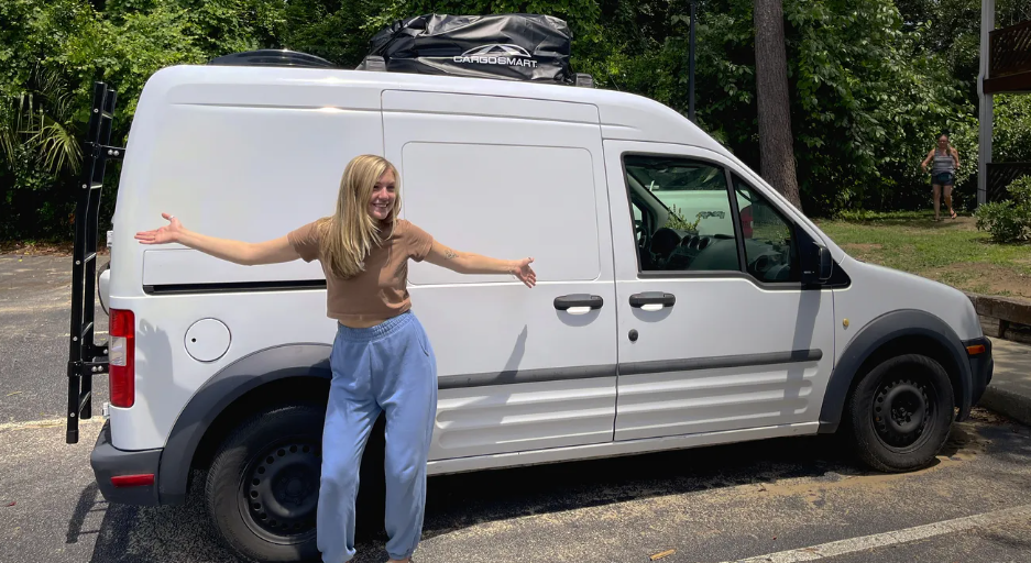 Gabby Petito posing outside the van during their #vanlife adventure.