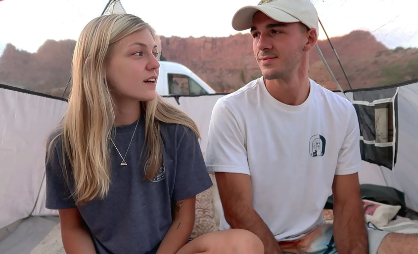 Petito and Laundrie sitting inside their van, engaged in conversation, during their road trip, as seen in American Murder: Gabby Petito.