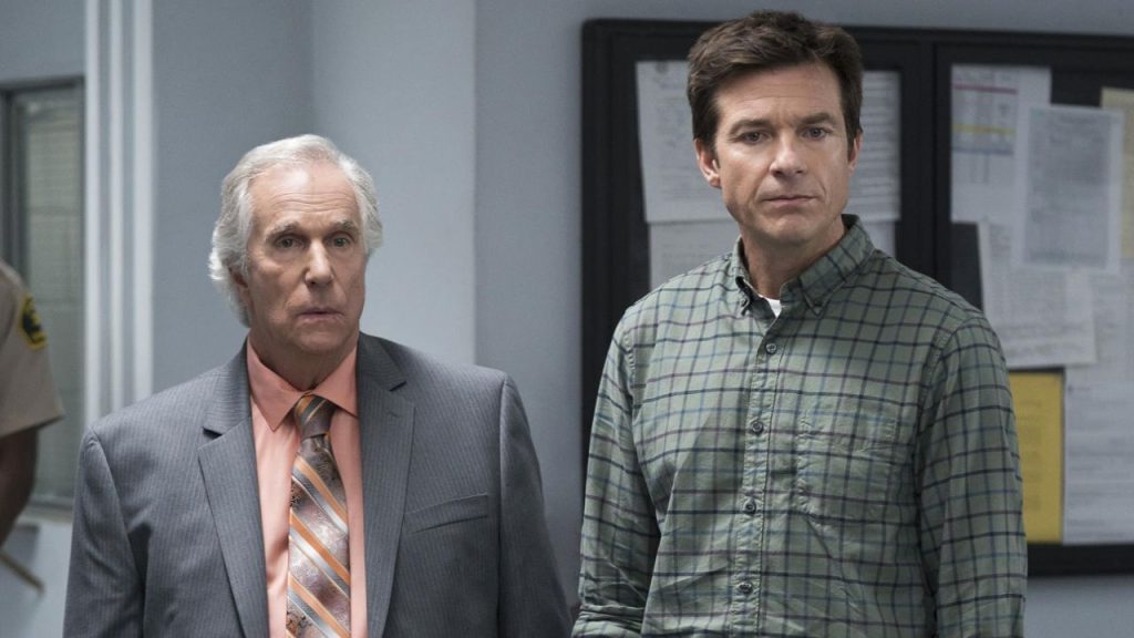 Jason Bateman and Henry Winkler standing beside each other in Arrested Development