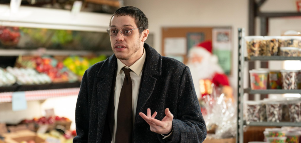 Pete Davidson in Riff Raff, dressed in a sharp, formal outfit while shopping.