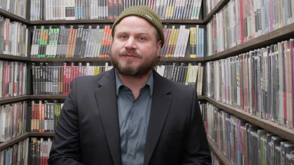 Brady Corbet standing in a closet